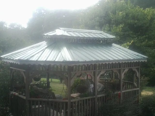 Two tier green metal roof on a garden gazebo in Pelham