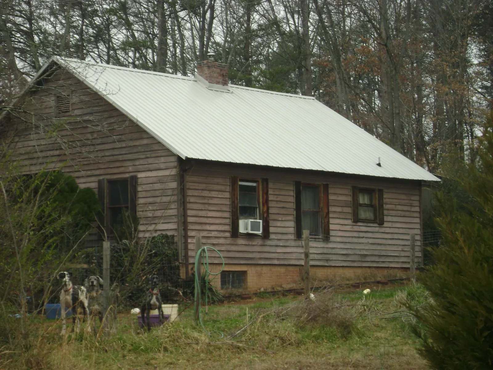 White metal roof on an old wood sided farmhouse, from a Asphalt Shingle Roof Repair job in Pelham